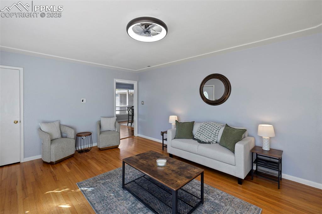 Image 4 of 30: Living room featuring light wood-type flooring and baseboards
