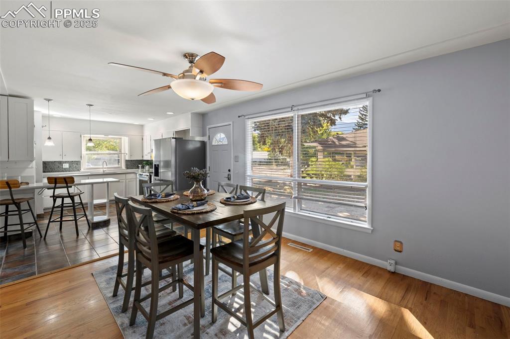 Image 9 of 30: Dining room with ceiling fan and light wood-style flooring