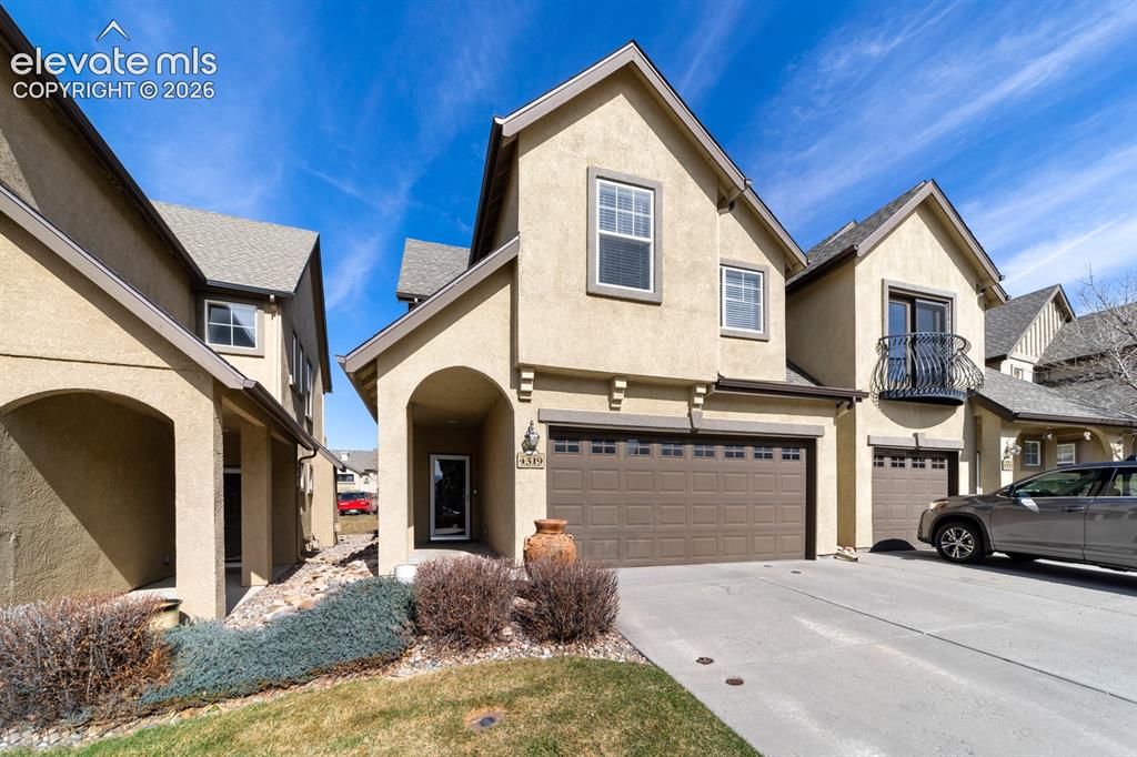 Image 2 of 24: Stucco exterior featuring an arched entryway, recessed porch, decorative me