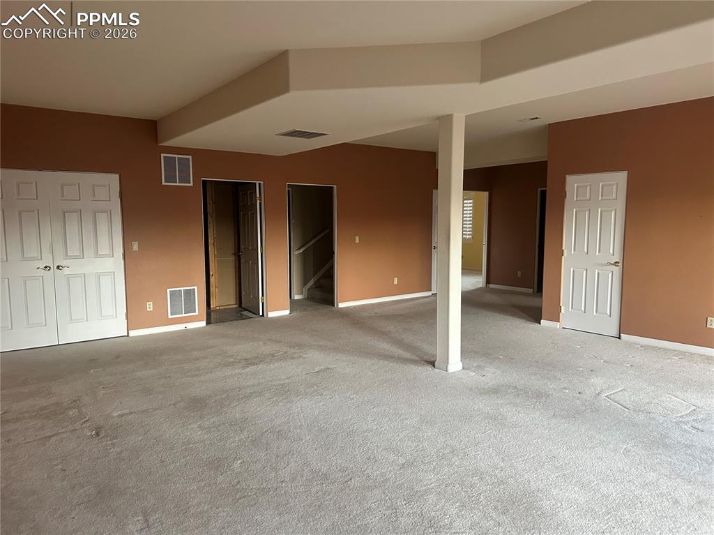 Image 29 of 39: Family room has two sliding glass doors to the deck