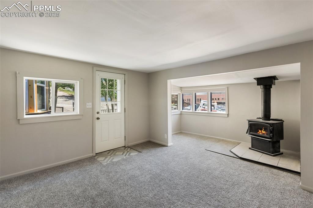 Image 15 of 36: The front door enters the living room, note heavy vinyl just inside the doo