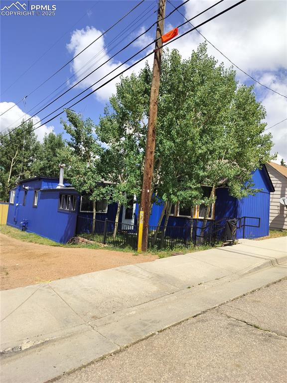 Image 2 of 36: This shot shows the front and south side of the home, the alley provides ac
