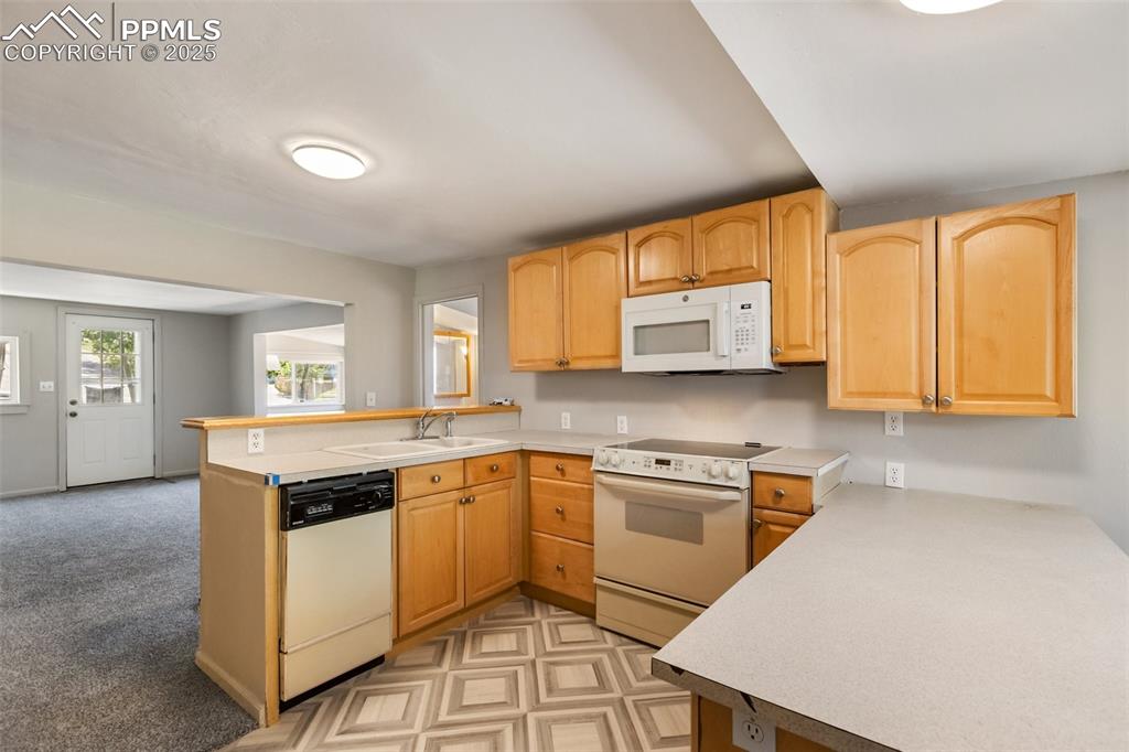 Image 24 of 36: good view of the entry door and the upscale wood cabinets. There are a lot