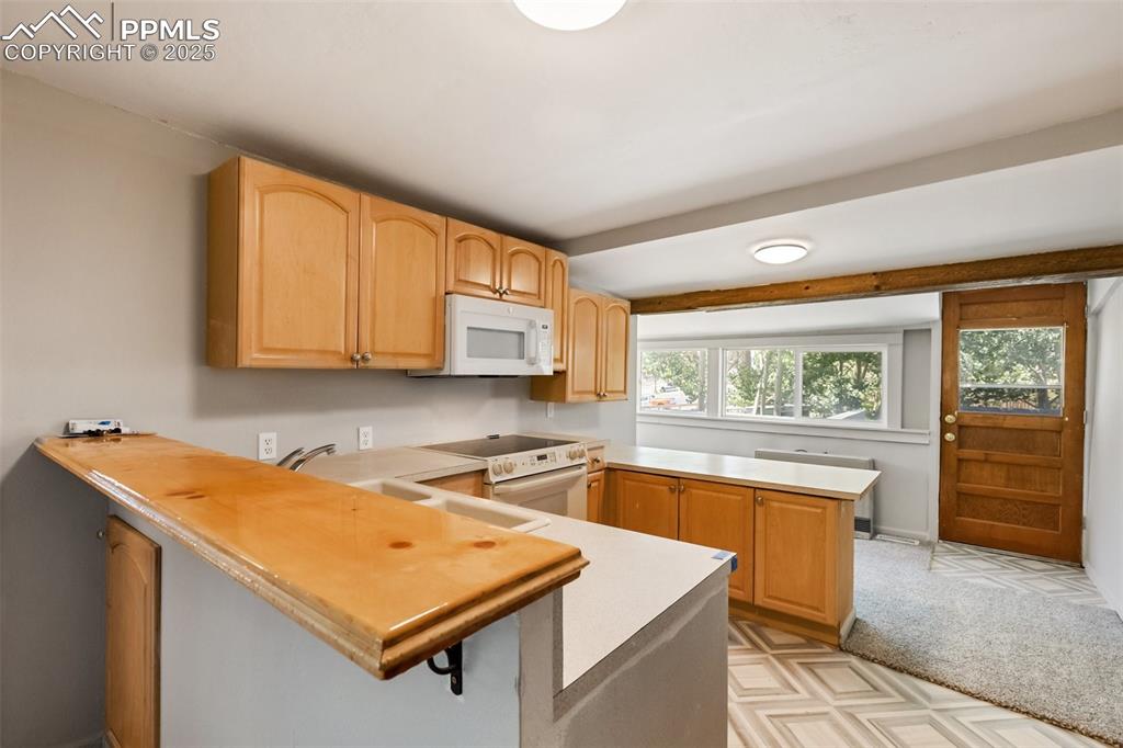Image 25 of 36: looking the other way in the kitchen you can see more cabinet space, the re