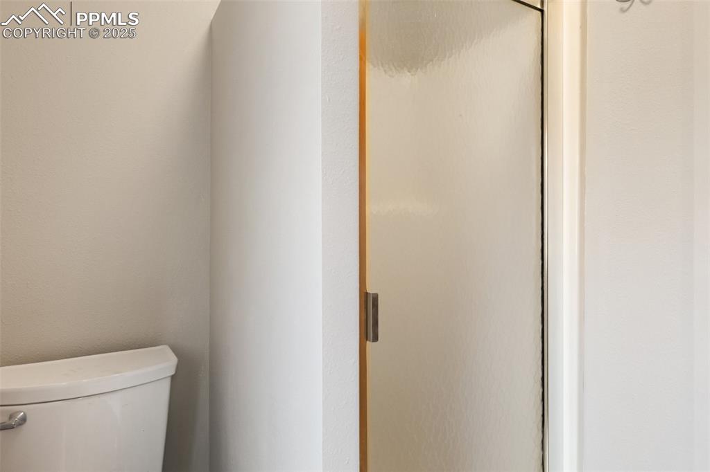 Image 27 of 36: stool and shower in the 3/4 bathroom