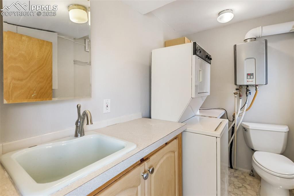 Image 32 of 36: here is a surprise, the laundry room is also a half bath, with sink includi