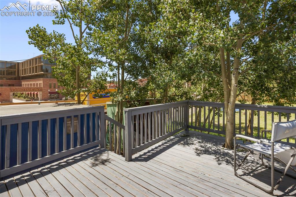 Image 5 of 36: this is the wooden deck out of the back door, and the steps leading down in
