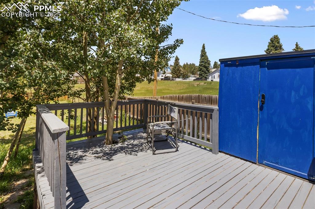 Image 6 of 36: this picture of the deck shows a storage shed on the deck level.