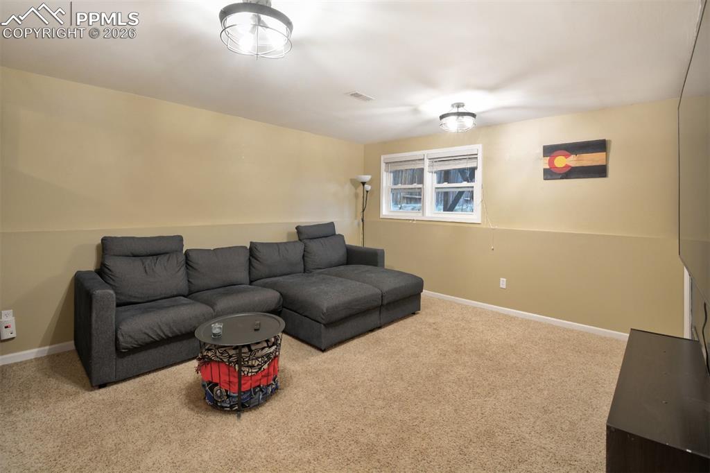 Image 25 of 27: Lower level family room with garden level window.
