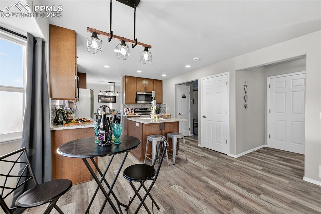 Image 11 of 50: The eat-in dining area and the island with seating as well.