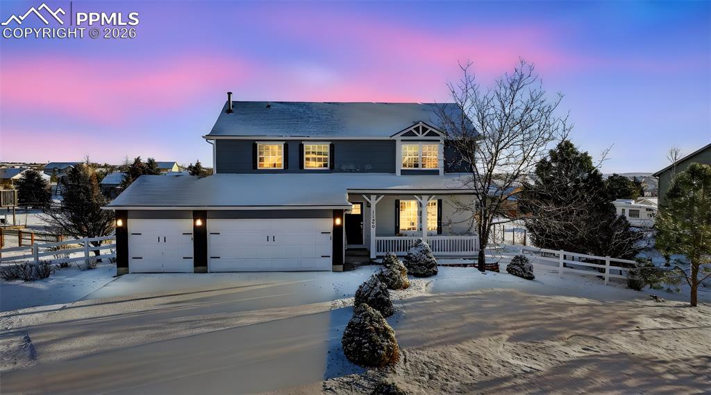 Image 2 of 50: The home looks beautiful during the evening hours.