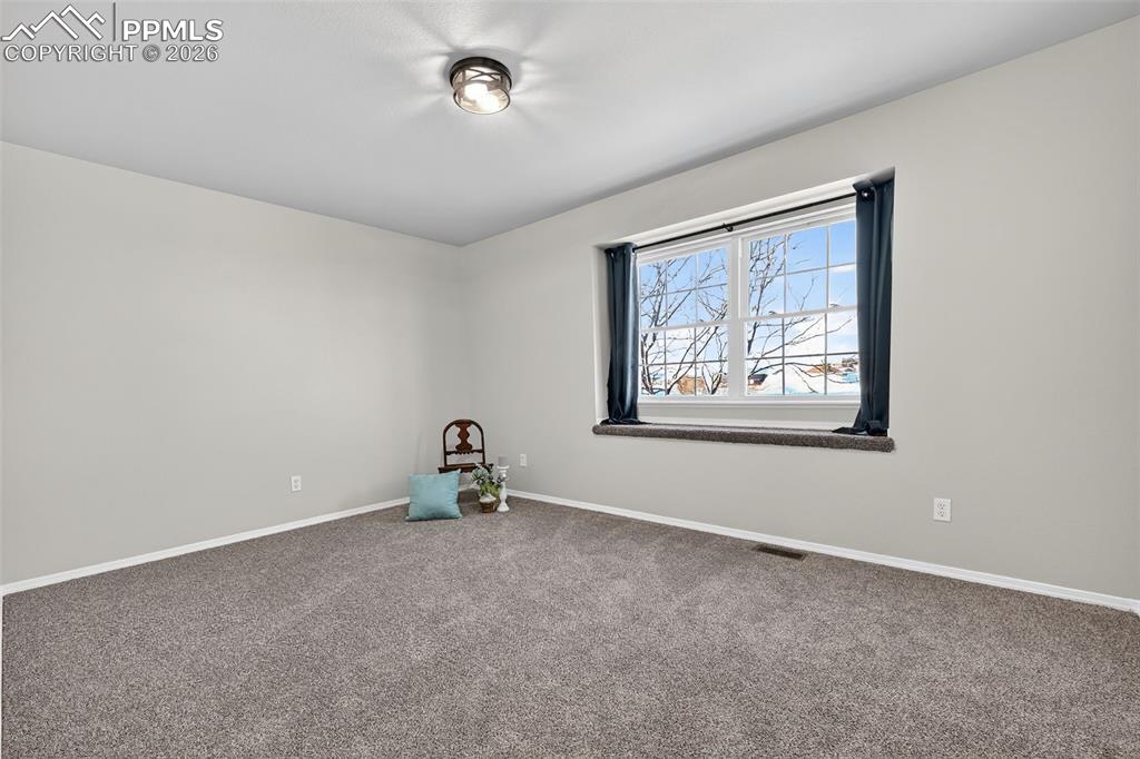 Image 34 of 50: A secondary bedroom on the 2nd floor with a window seat.