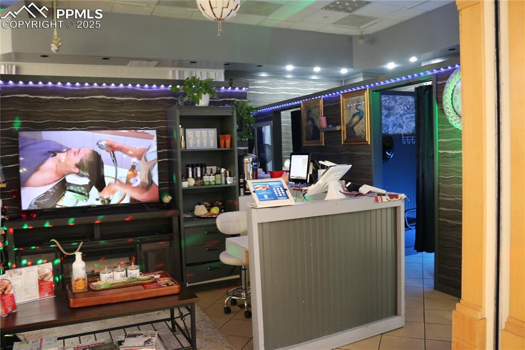 Image 2 of 5: Office space featuring tile patterned flooring and a drop ceiling