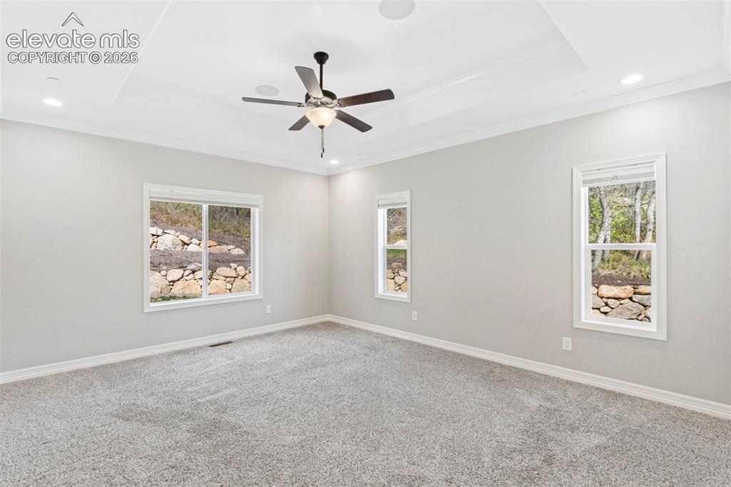 Image 23 of 47: Expansive room featuring light gray carpeting, neutral wall finishes, and a