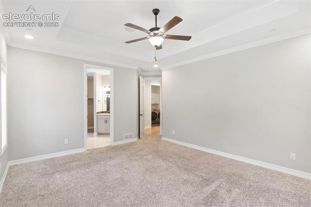 Image 24 of 47: Spacious carpeted room featuring a ceiling fan, recessed lighting, and a tr