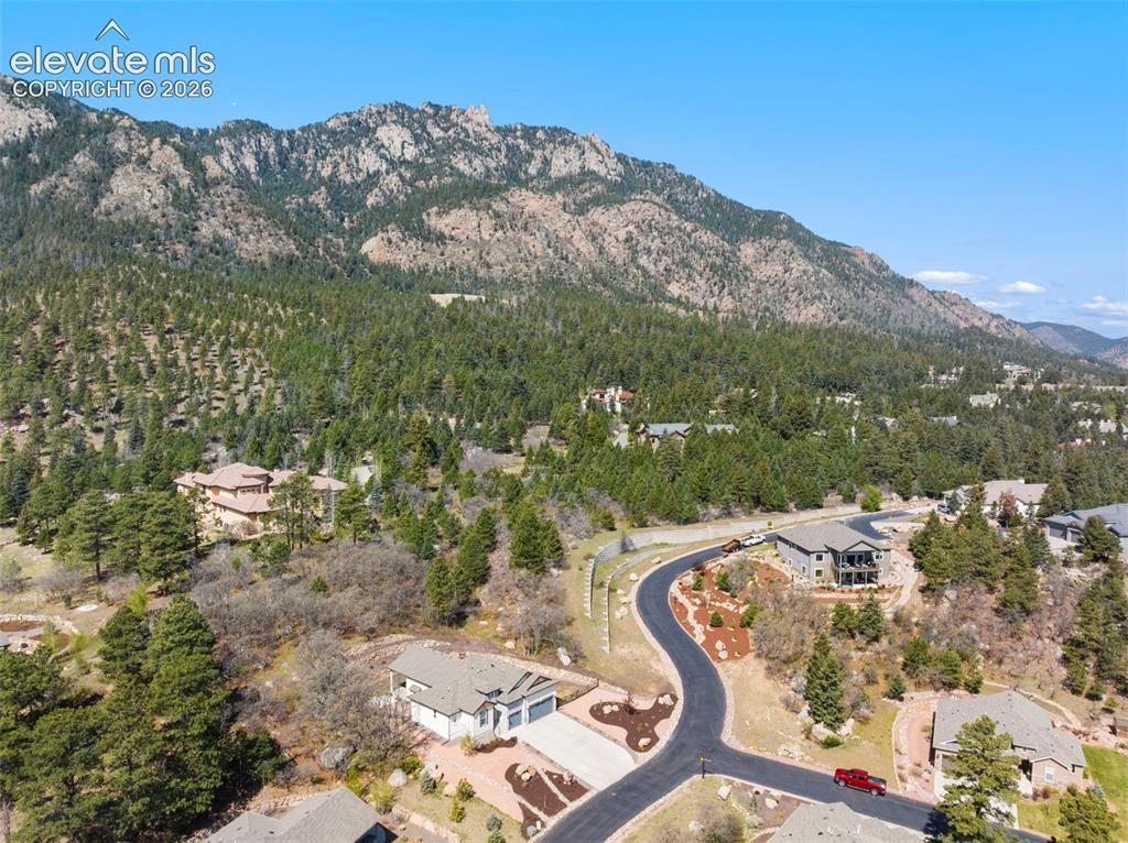 Image 3 of 47: Paved cul-de-sac with homes nestled into the mountainside