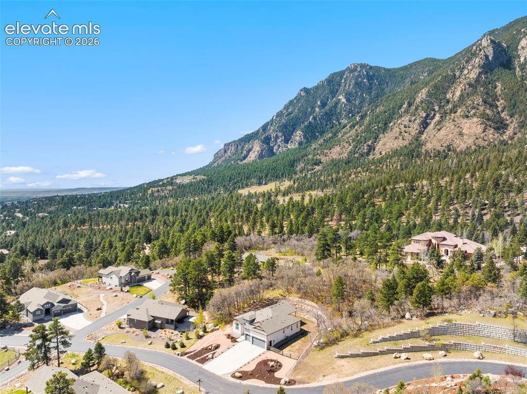 Image 4 of 47: Expansive mountain landscape featuring dense evergreen forests and rock for