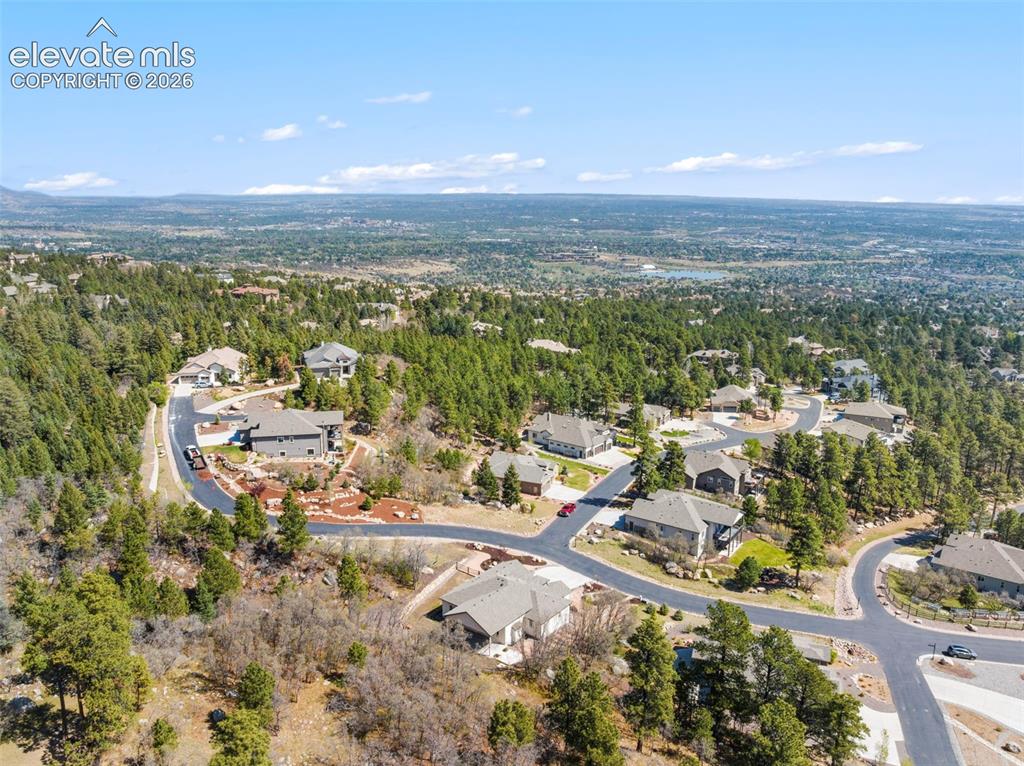 Image 6 of 47: Aerial perspective showcasing a residential area amidst extensive mature tr