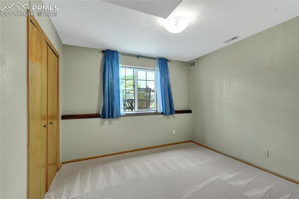 Image 14 of 32: Unfurnished bedroom with light colored carpet and a closet