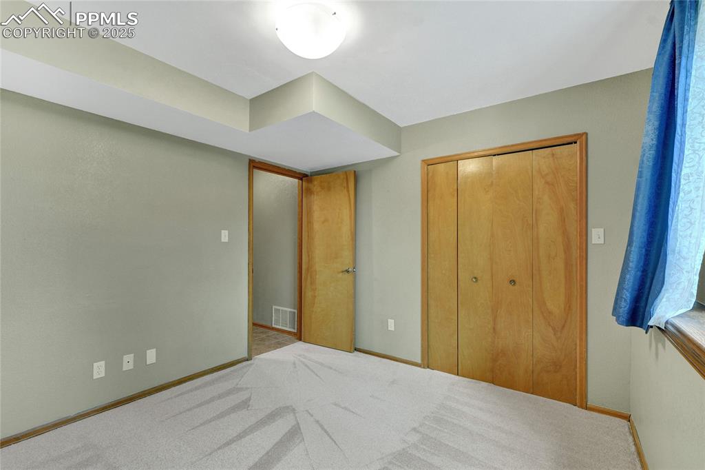 Image 15 of 32: Carpeted bedroom featuring baseboards and a closet