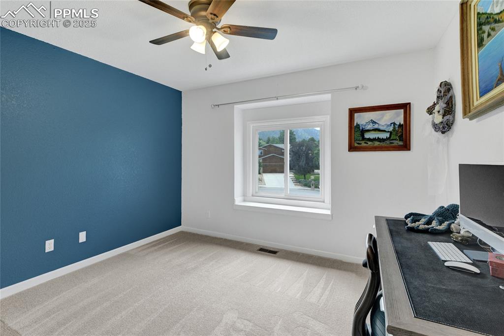 Image 18 of 32: Carpeted office with baseboards and ceiling fan