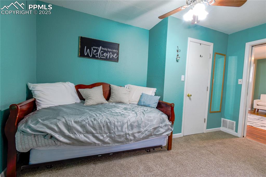 Image 10 of 30: Carpeted bedroom featuring baseboards and ceiling fan