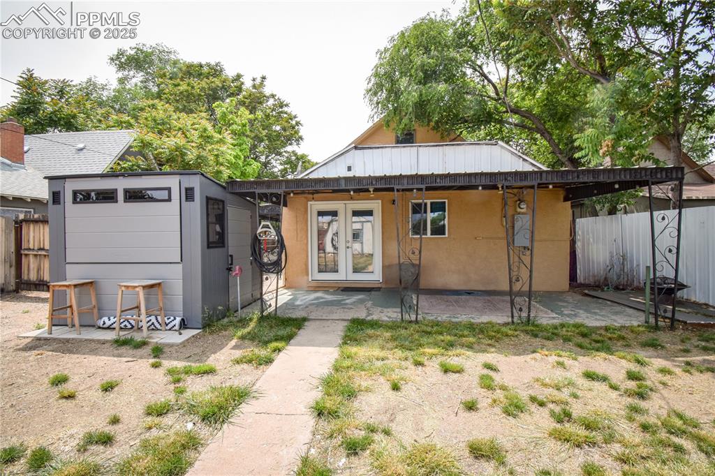 Image 22 of 30: Rear view of house with a patio area and french doors