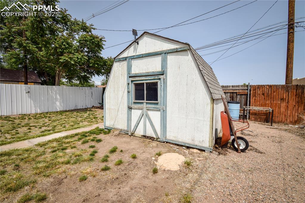 Image 23 of 30: View of shed featuring a fenced backyard