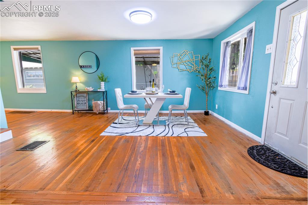 Image 3 of 30: Dining space with hardwood / wood-style flooring, healthy amount of natural