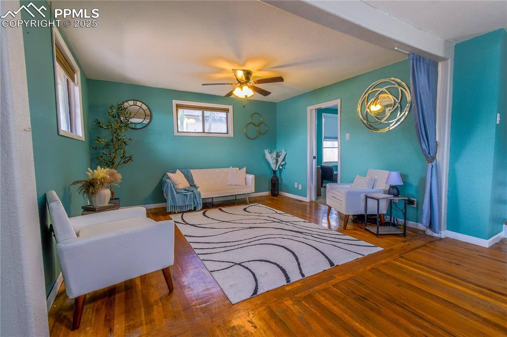 Image 4 of 30: Living room with plenty of natural light, wood-type flooring, a ceiling fan