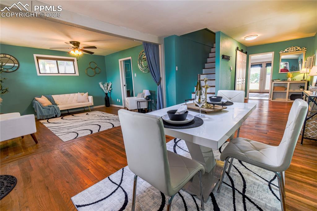 Image 7 of 30: Dining area featuring wood finished floors, ceiling fan, beamed ceiling, an