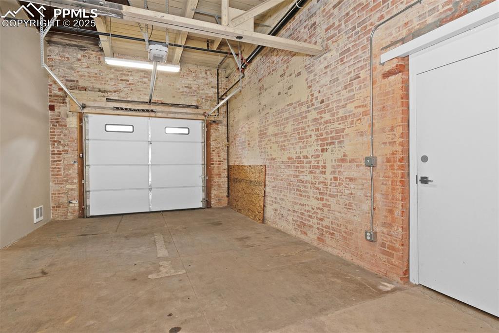 Image 28 of 33: Community garage attached to the building, as well as access to on-site pri