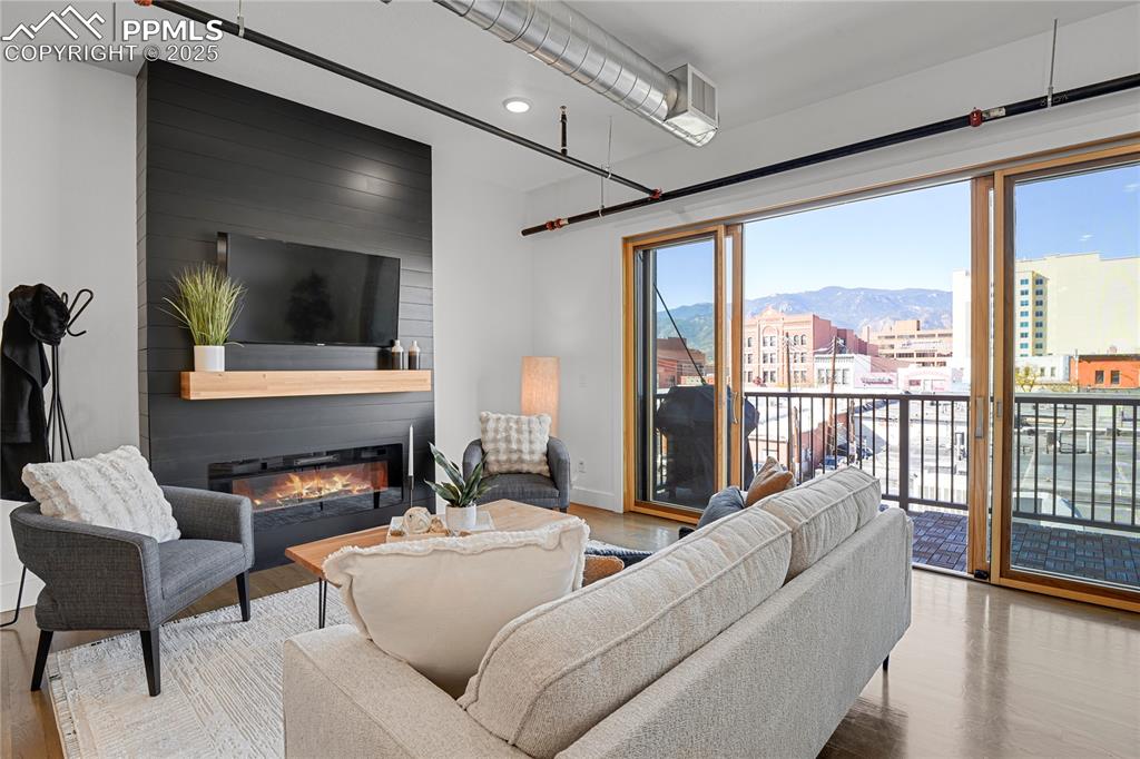 Image 4 of 33: Sleek electric fireplace adds warmth and ambiance to the living area