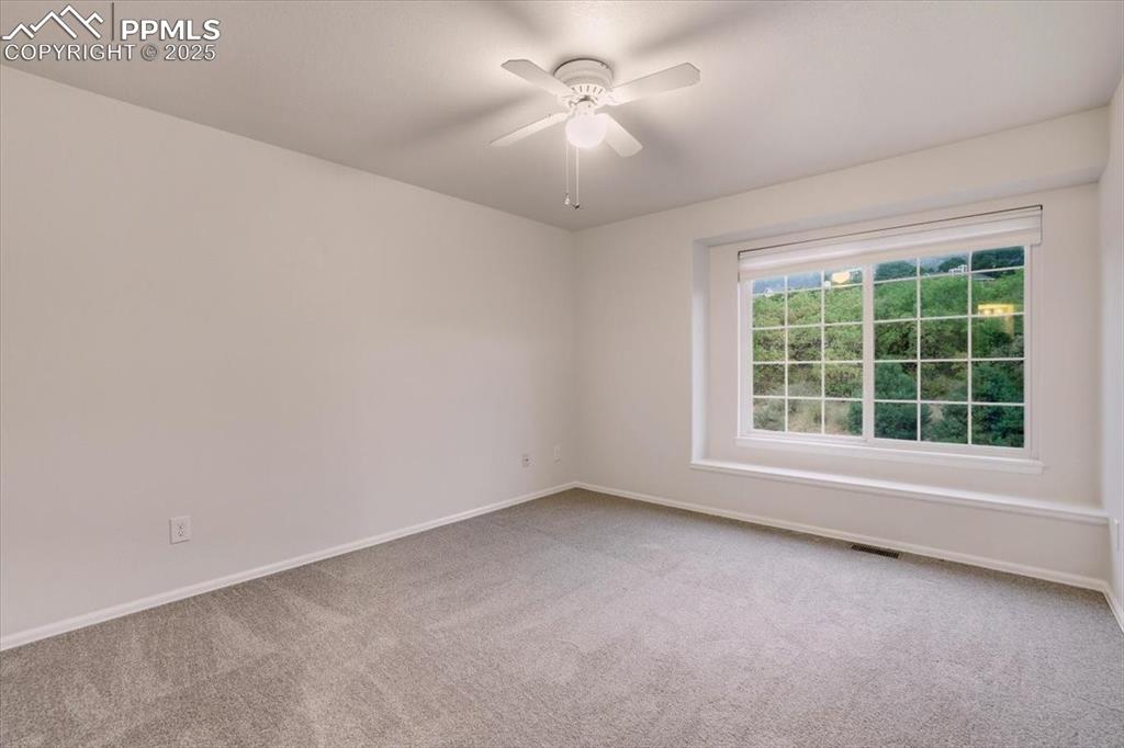 Image 22 of 31: Spare room featuring light carpet and ceiling fan