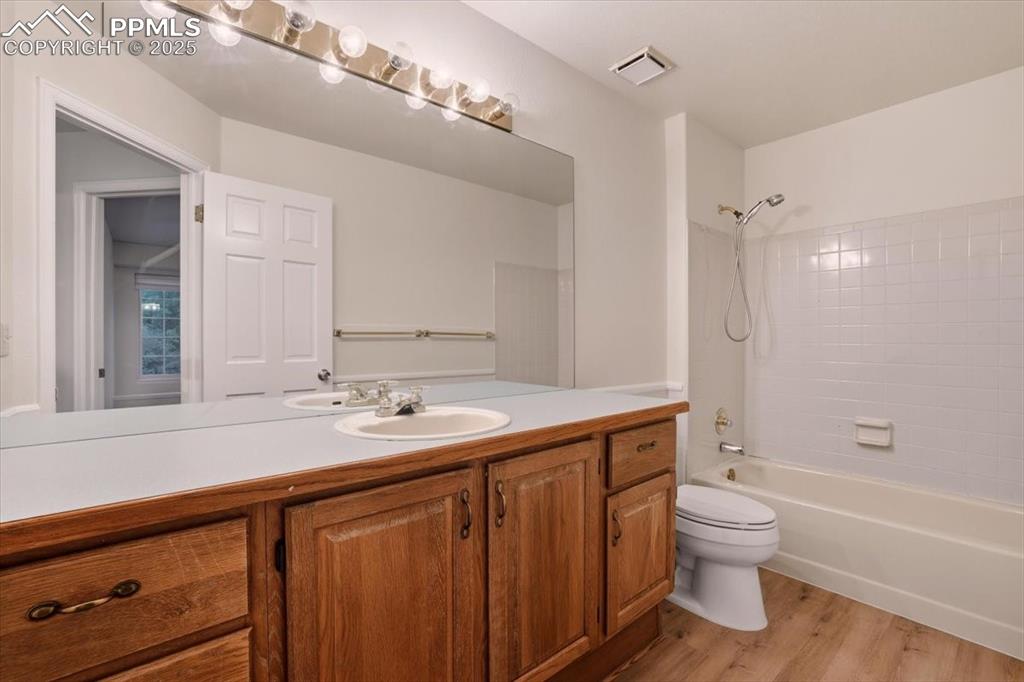 Image 23 of 31: Full bath with light wood-type flooring, shower / washtub combination, and