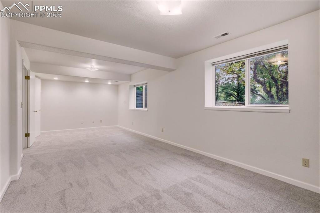 Image 26 of 31: room featuring light carpet and baseboards