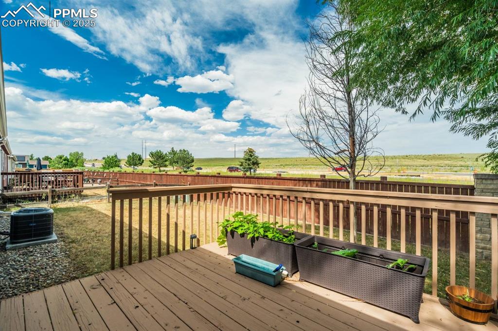 Image 23 of 35: Wooden deck with a fenced backyard and a view of rural / pastoral area