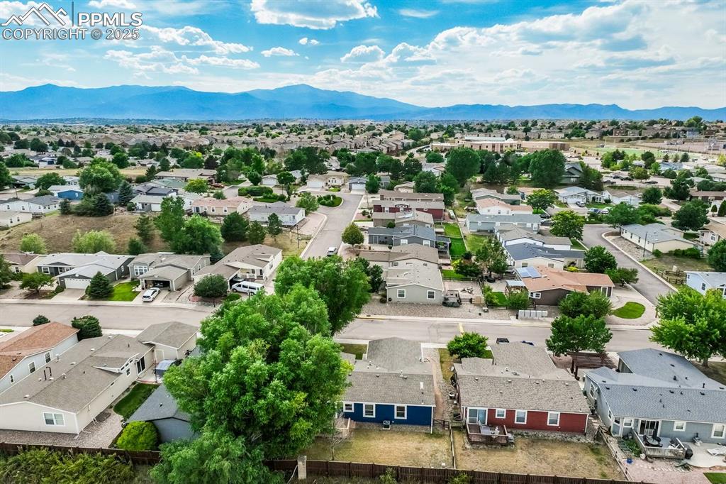 Image 28 of 35: Aerial view of residential area featuring mountains