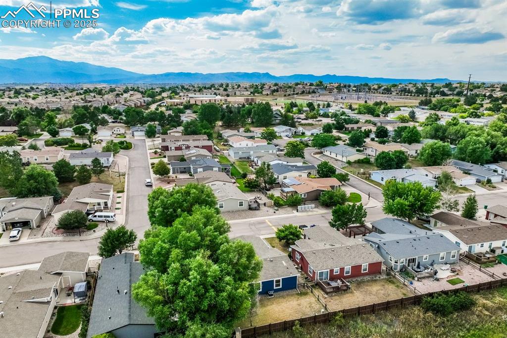 Image 29 of 35: Aerial perspective of suburban area with mountains