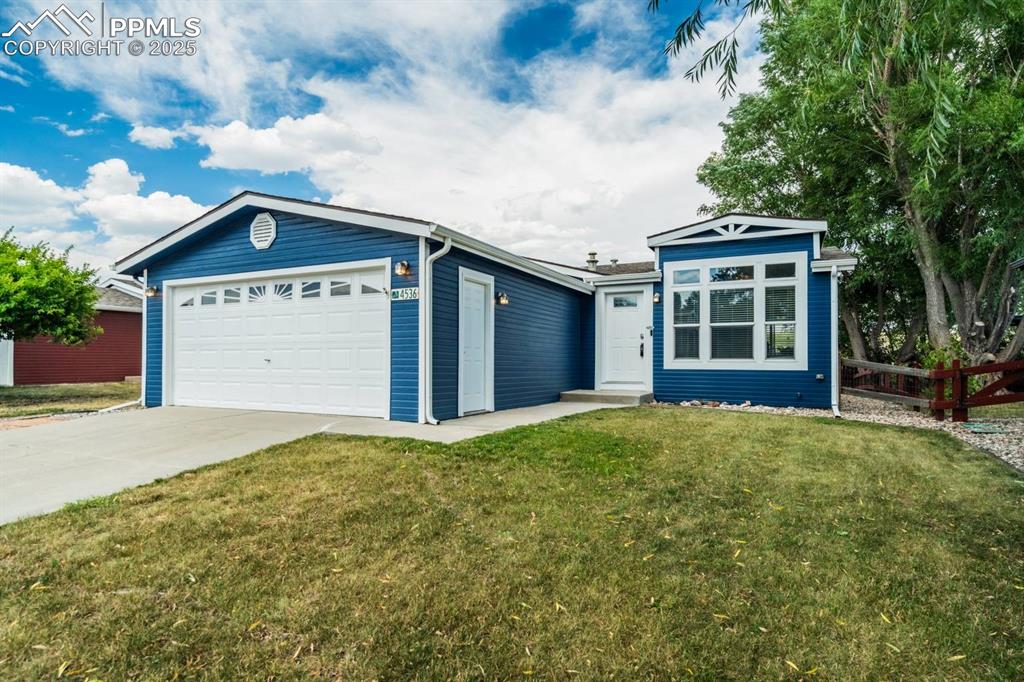 Image 32 of 35: Ranch-style home featuring concrete driveway and a garage