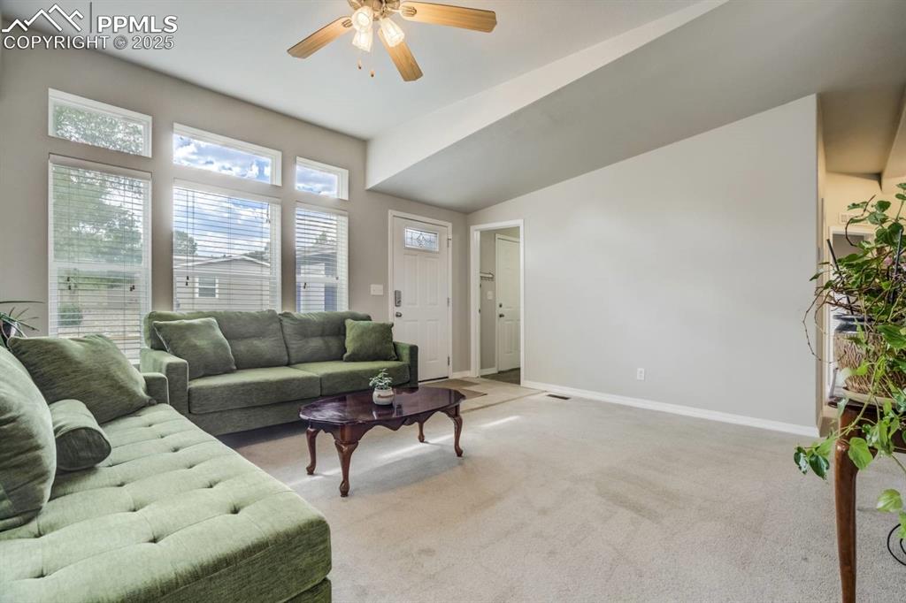 Image 5 of 35: Living room featuring light carpet and a ceiling fan