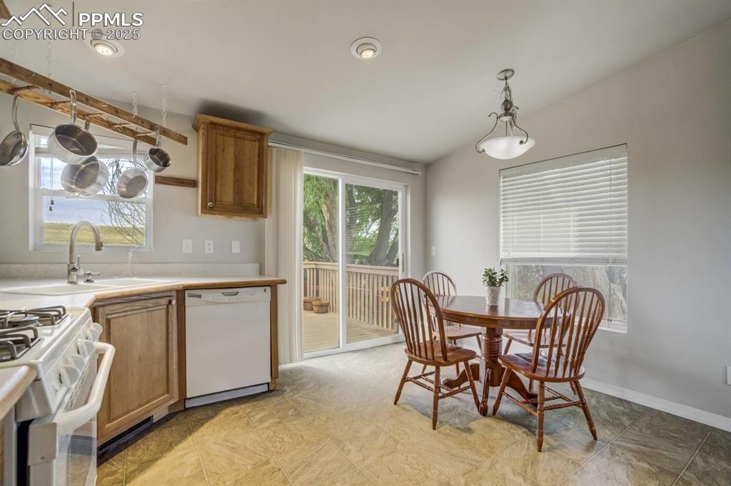 Image 8 of 35: Kitchen featuring brown cabinets, light countertops, dishwasher, healthy am