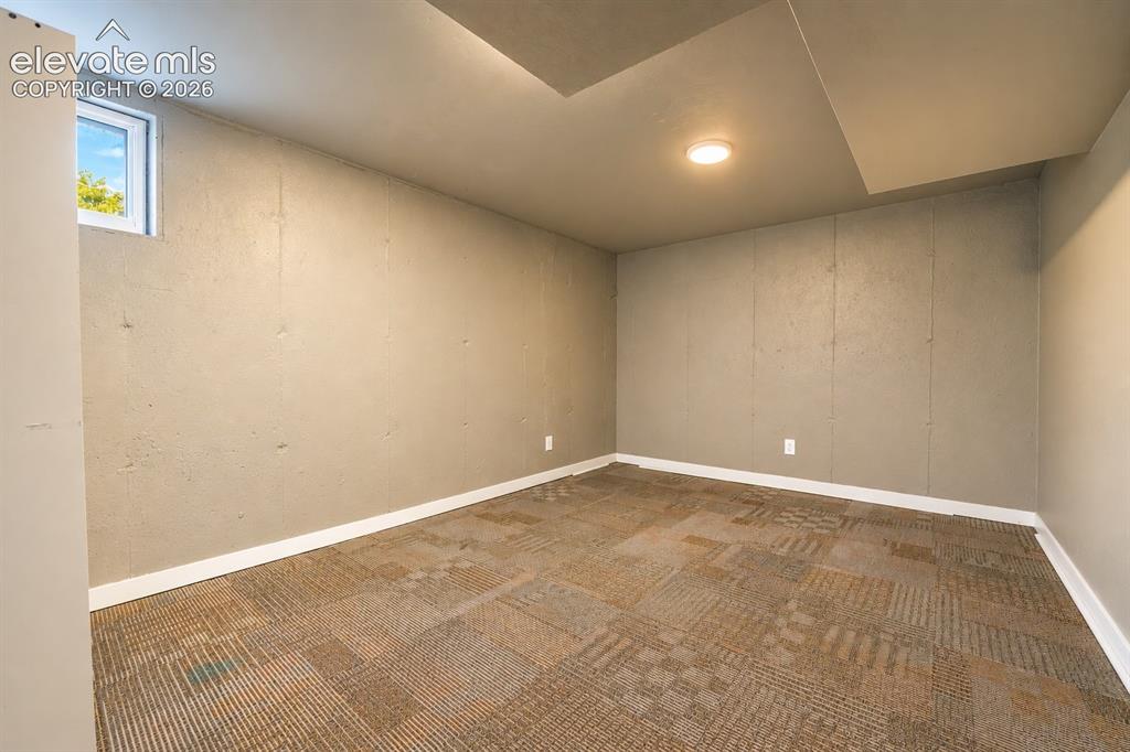 Image 21 of 29: Window with white trim, recessed ceiling light, patterned carpet flooring, 