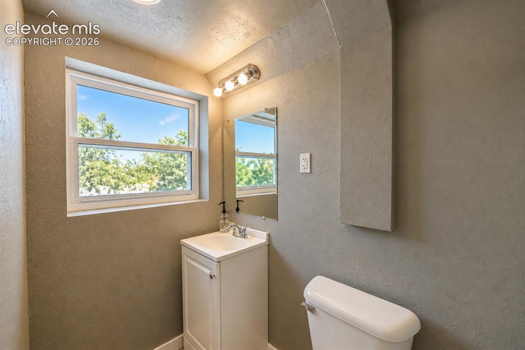 Image 24 of 29: White framed window, recessed lighting, white vanity cabinet, chrome-finish