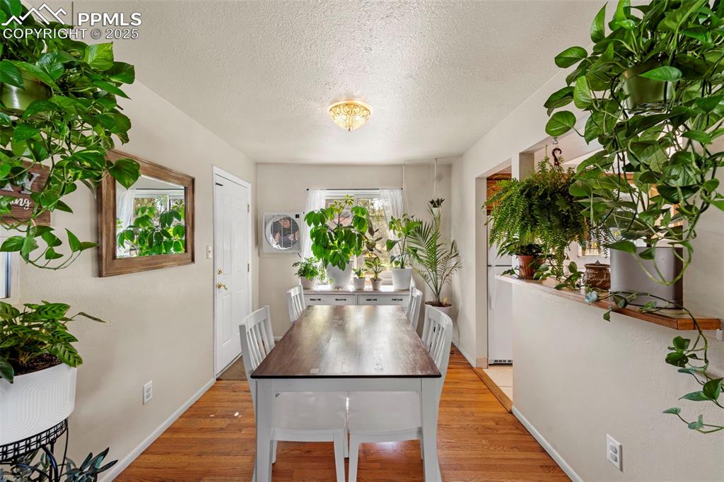 Image 16 of 38: Dining space featuring light wood finished floors and a textured ceiling