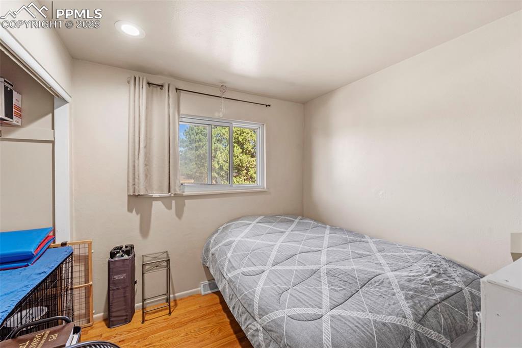 Image 24 of 38: Bedroom featuring wood finished floors and recessed lighting