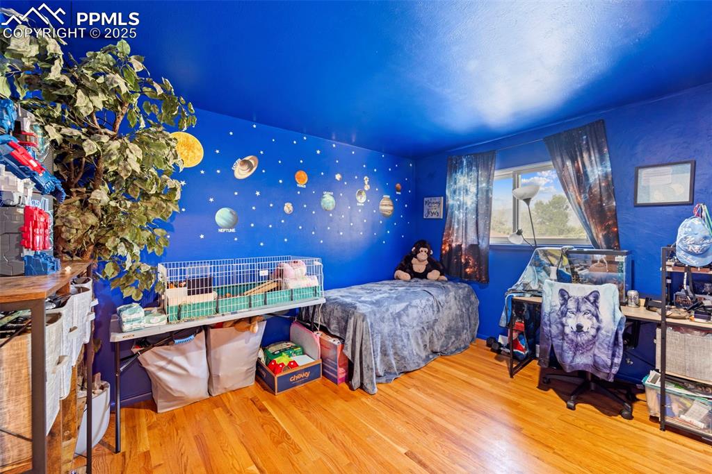 Image 25 of 38: Bedroom with wood finished floors
