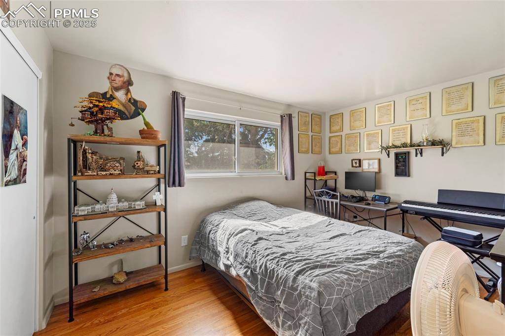 Image 26 of 38: Bedroom featuring wood finished floors and baseboards