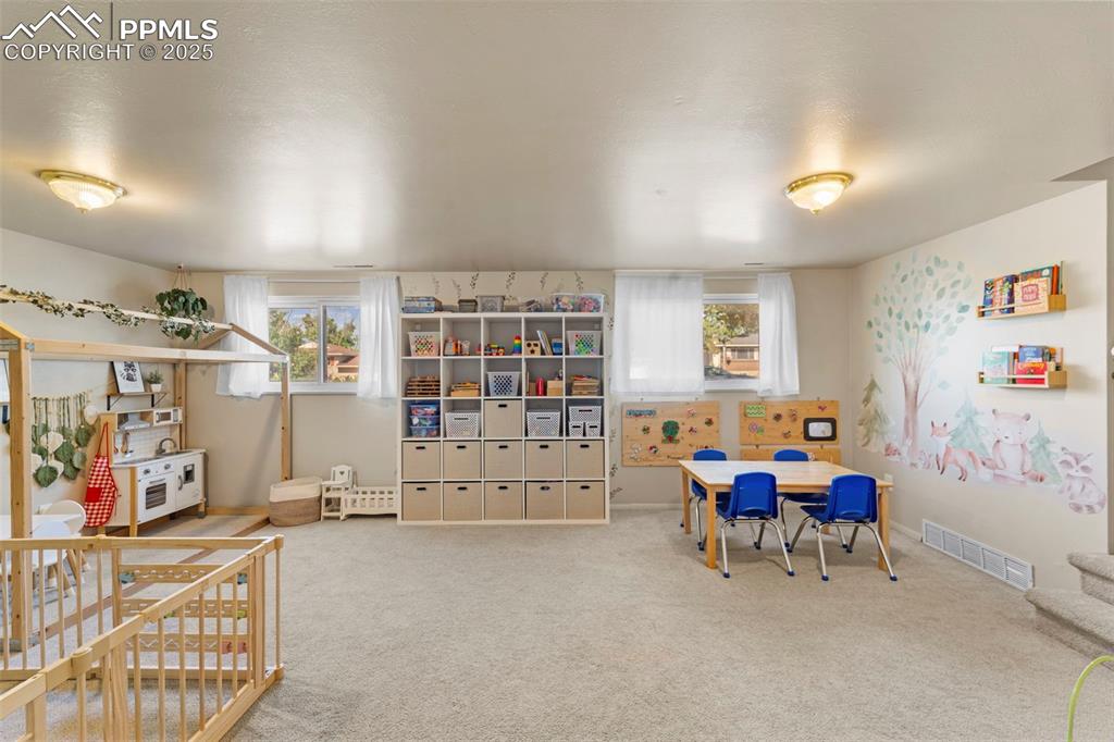 Image 29 of 38: Game room with healthy amount of natural light and carpet