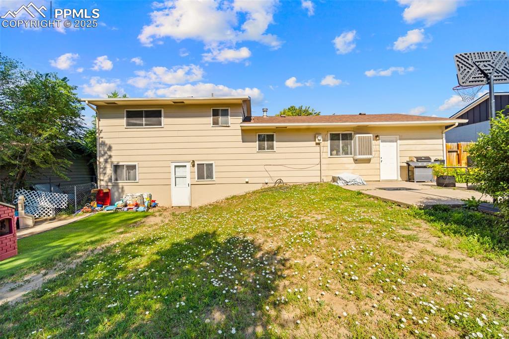 Image 34 of 38: Rear view of house with a patio
